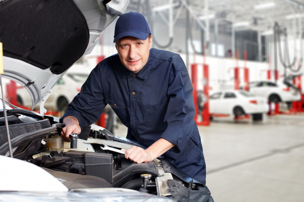 professional auto mechanic working in the shop garage