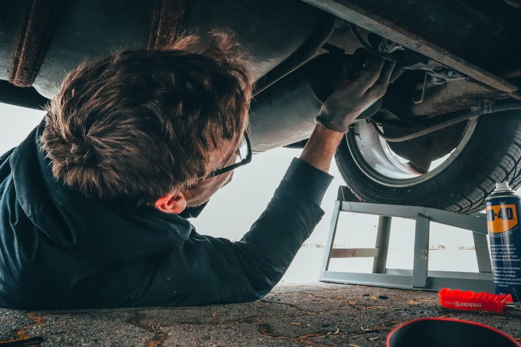 man fixing a car